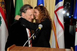 Canadian astronaut Julie Payette helps Herzberg winner John Polanyi with his medal.